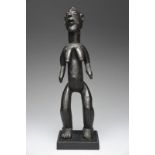 An Afo standing female figure Nigeria with a crested coiffure and pierced ears, having an open mouth
