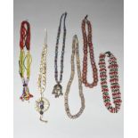 An African cowrie shell and glass bead necklace 44cm long and five glass beads necklaces, Africa and