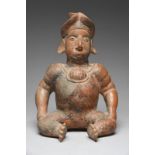 A Jalisco seated male figure Mexico, circa 100 BC - 200 AD pottery, with a spout to the head and a