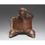 A Nayarit seated male figure vessel Mexico, circa 100 BC - 250 AD earthenware, with his left hand on