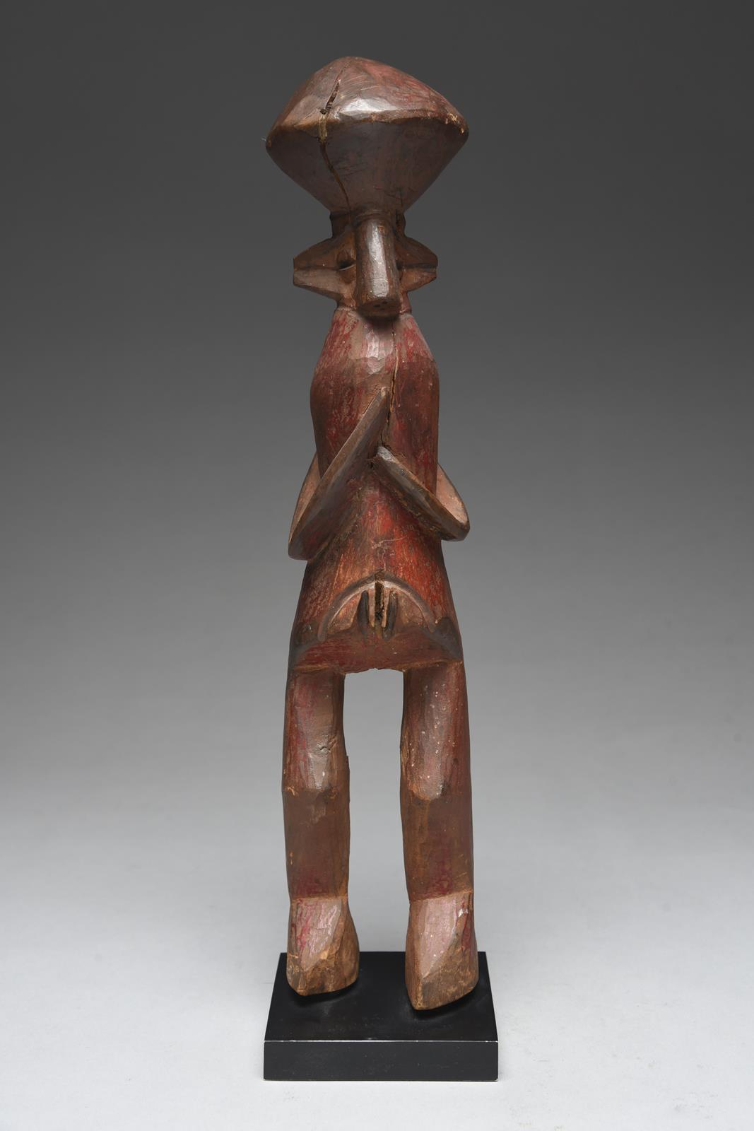 A Yaka standing female figure Nigeria with a lozenge coiffure, wide ears and grooved eyes, with