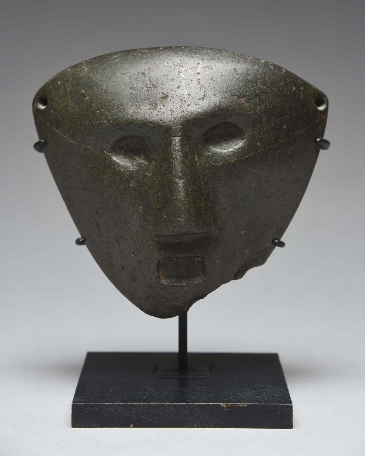 A Mezcala mask Guerrero, Mexico, circa 300 BC - 300 AD serpentine, with recessed ovoid eyes and