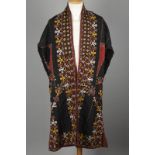 A Tekke Turkman mantle / cloak chypry embroidered on a black ground with sleeves joined with a