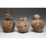 Three Peru vessels including a Moche mask vessel, circa 450 - 550 AD, representing a jaguar