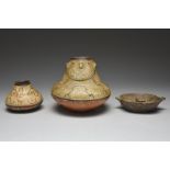 A Shipibo mask vessel Peru pottery, 17cm high, another smaller Shipibo vessel and a Bolivian