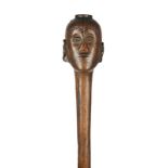 A Lwena staff Angola with a carved head finial having facial scarifications and quartered coiffure