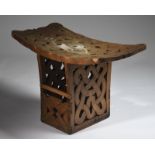 A Suriname large stool South America with a curved rectangular top having a pierced interlaced