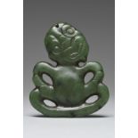 A Maori hei-tiki pendant New Zealand nephrite, with a tilted head and with the hands on the