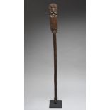 A Chimu rattle staff Peru, circa 1200 - 1400 AD the top carved a seated dignitary wearing a arched