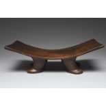 A Cook Islands stool Polynesia with a curved waisted rectangular seat on four curved legs with