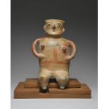 A Zacatecas seated female figure urn Mexico, circa 250 - 550 AD pottery, with pierced eyes, mouth