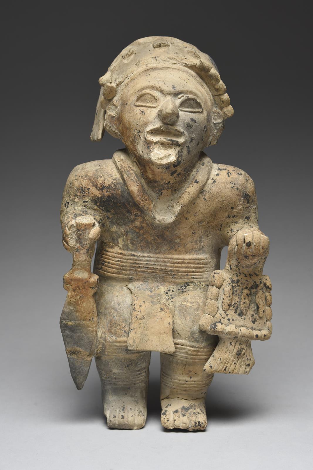 A Jama Coaque standing warrior Ecuador, circa 500 BC - 600 AD pottery, wearing a headdress, necklace