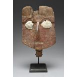 A Chancay mask Peru, circa 1100 - 1450 AD with a prominent nose, a carved mouth and eyebrows, with