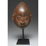 A Yoruba gelede mask Nigeria with a high forehead, scroll top ears, navette eyes with square