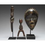 A Yoruba divination tapper Nigeria with a carved seated female figure, 27.5cm long, mounted, a