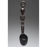 An Ifugao ladle Luzon Islands, Philippines with a standing male figure handle and a ring