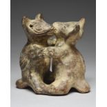 A Colima dancing dogs group Mexico earthenware, standing on their hind legs with ribbed spines,