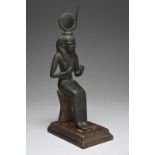 An Egyptian bronze figure of Isis Late Period, circa 664 - 332 BC seated, wearing the horned solar