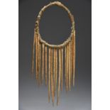 A Northwest Coast Shaman's neck ring wood, cloth and twenty bone needle like pendants, 25.5cm