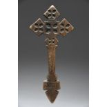 An Ethiopian Coptic cross with pierced and carved decoration and with incised script to the base