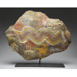 An Inca Chucu stone tablet Peru, circa 900 - 1400 AD decorated with wavy lines, horned animals and a