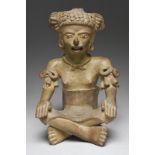 A Veracruz seated female figure Mexico, circa 500 -700 AD pottery, wearing an ornate headdress and