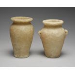 Two Egyptian alabaster jars with everted rims, the smaller with a pair of pierced side handles, 16.