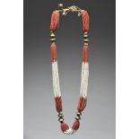 A Mizoram necklace North Eastern India red and white glass beads and brass pentagon beads, 60cm