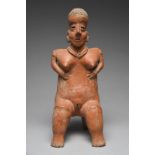 A Nayarit seated female figure Mexico, circa 100 BC - 250 AD pottery, with a linear incised coiffure