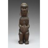 A Kamba maternity figure Kenya seated with a baby on her back and with an applied hide satchel front