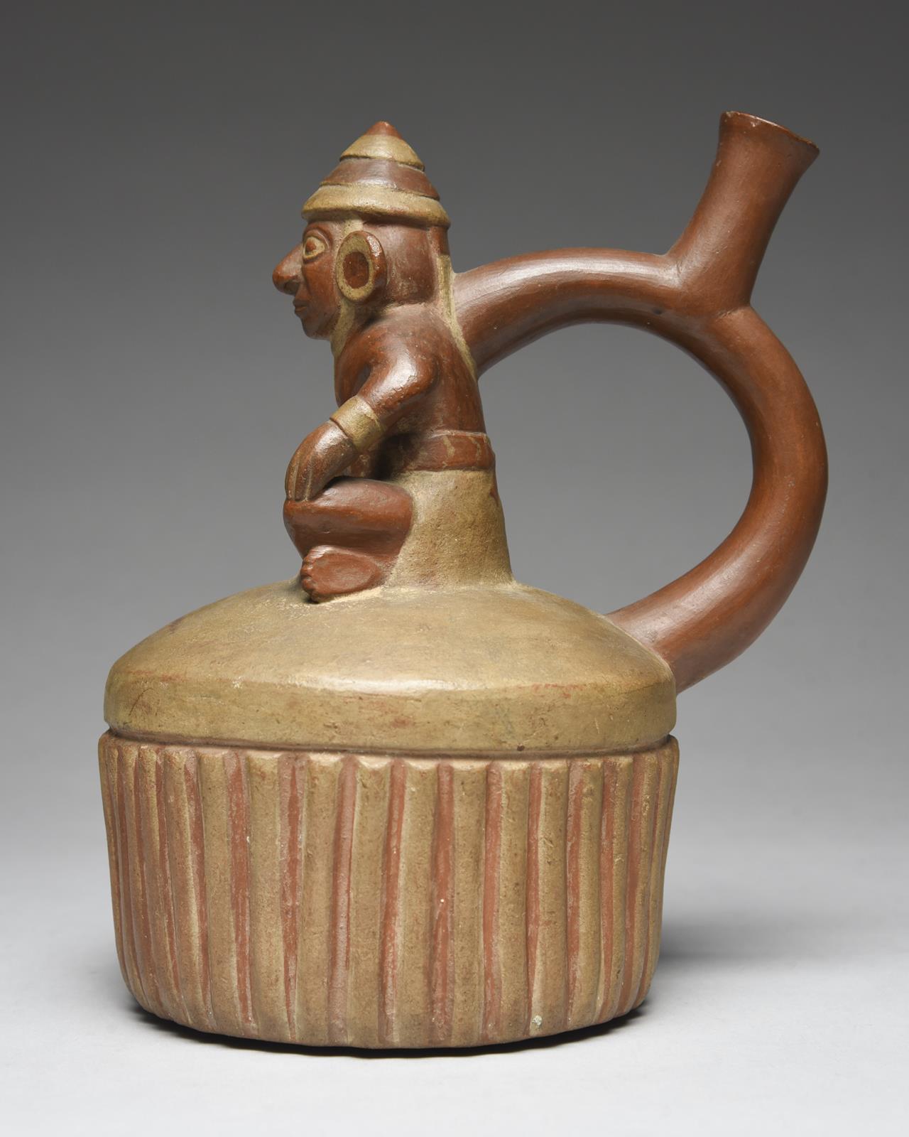 A Moche stirrup spout vessel Peru, circa 400 - 700 AD of circular ribbed form with a domed top - Image 2 of 5