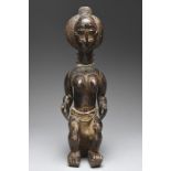 An Attie seated female figure Ivory Coast with articulated arms and wearing glass beads and a loin