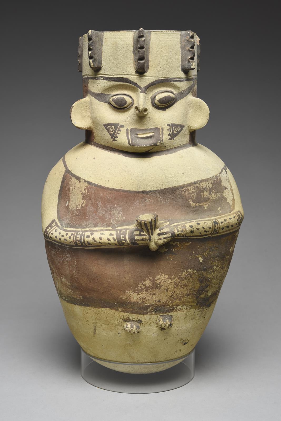 A Chancay figural vessel Peru, circa 1100 - 1400 AD pottery, relief modelled holding a cup, with a