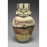 A Chancay figural vessel Peru, circa 1100 - 1400 AD pottery, relief modelled holding a cup, with a