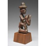 A Yoruba miniature equestrian group Nigeria the seated male figure wearing a hat and holding a