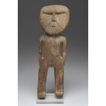 A Huari standing figure Peru, circa 1200 AD with carved and black pigment detailing to the face,