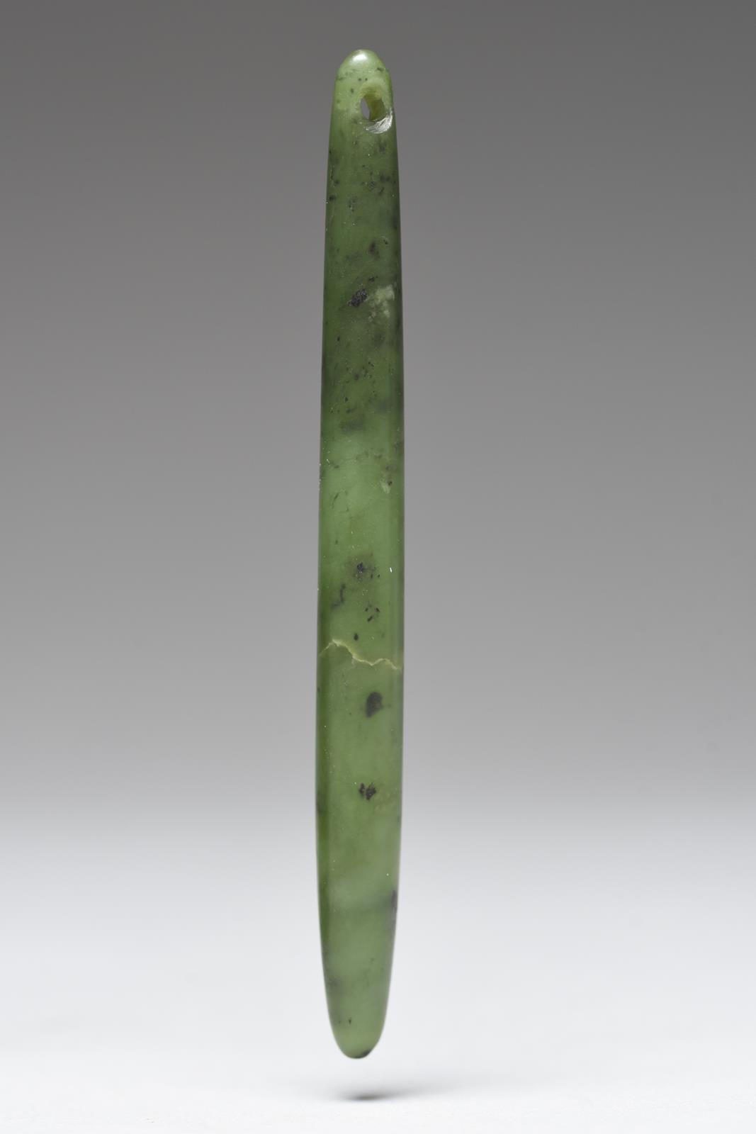 A Maori ear pendant New Zealand nephrite, with a pierced suspension hole to the top, 12.2cm long. - Image 2 of 2