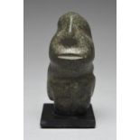 A Mezcala seated figure Mexico, circa 400 BC - 100 AD greenstone, with the head looking upwards, 9cm