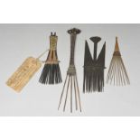 Four Melanesian combs Solomon Islands and Papua New Guinea one with red and natural fibre binding,