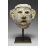 An Aztec head Mexico, circa 1300 - 1521 AD stone, with a cropped coiffure, almond shape eye recesses