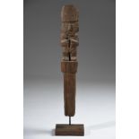 A Chimu female figural marker post Peru, circa 1100 - 1470 AD standing wearing a high domed