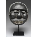 An Ogoni mask Nigeria with a pierced crest, plump cheeks and open below the eyes, temple keloids and