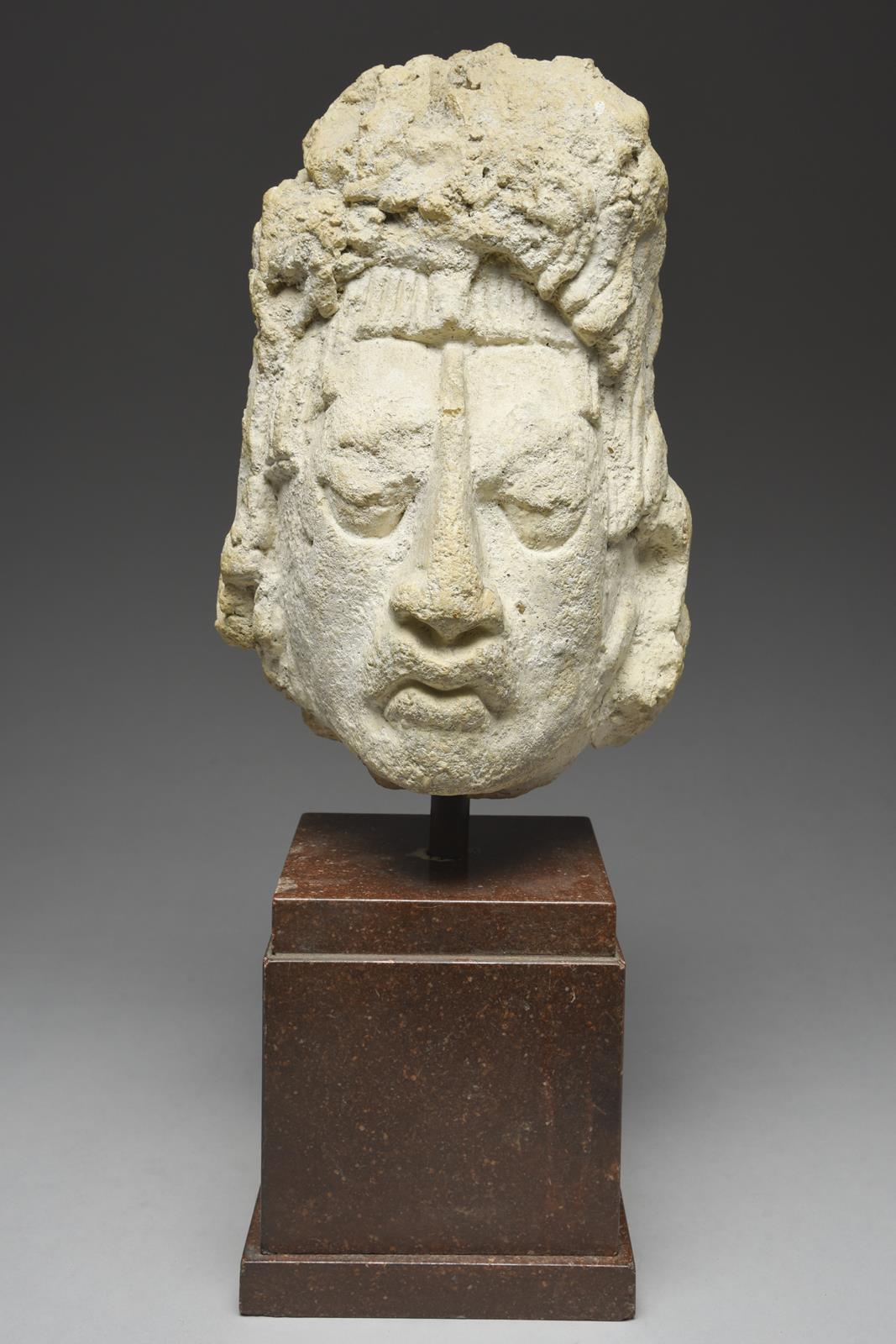 A Maya stucco head Mexico, circa 250 - 750 AD the finely modelled face with a roughly modelled