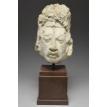 A Maya stucco head Mexico, circa 250 - 750 AD the finely modelled face with a roughly modelled