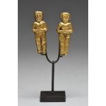 Two Chimu figural pendants Peru resin with gold leaf, one janus and all with hands folded onto the