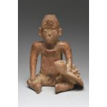 A Colima seated male figure Mexico, circa 100 BC - 250 AD pottery, with a spout to the top of the