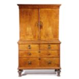 A QUEEN ANNE WALNUT CABINET ON CHEST C.1710 the upper section with a moulded cornice above a pair of