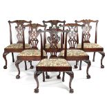 A SET OF SIX EARLY GEORGE III MAHOGANY DINING CHAIRS C.1760-70 a serpentine top rail carved with