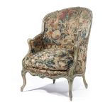 A FRENCH BERGERE ARMCHAIR IN LOUIS XV STYLE MID-19TH CENTURY the grey painted frame with floral