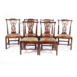 A SET OF EIGHT GEORGE III MAHOGANY DINING CHAIRS IN CHIPPENDALE STYLE, C.1760-70 each with a foliate